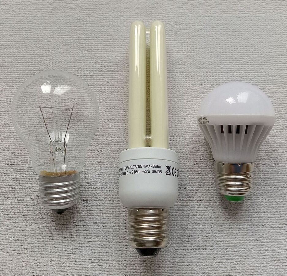 Do Energy-Efficient Light Bulbs Give Off Radiation? 11 Three distinct types of light bulbs displayed on a white surface, showcasing their varied shapes and sizes.