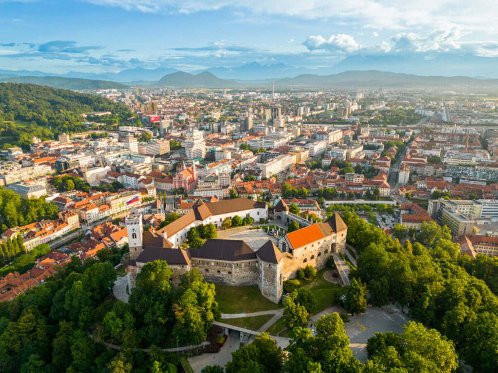 Aerial view of Ljubljana, Slovenia, showcasing the city's architecture and green spaces from above.
