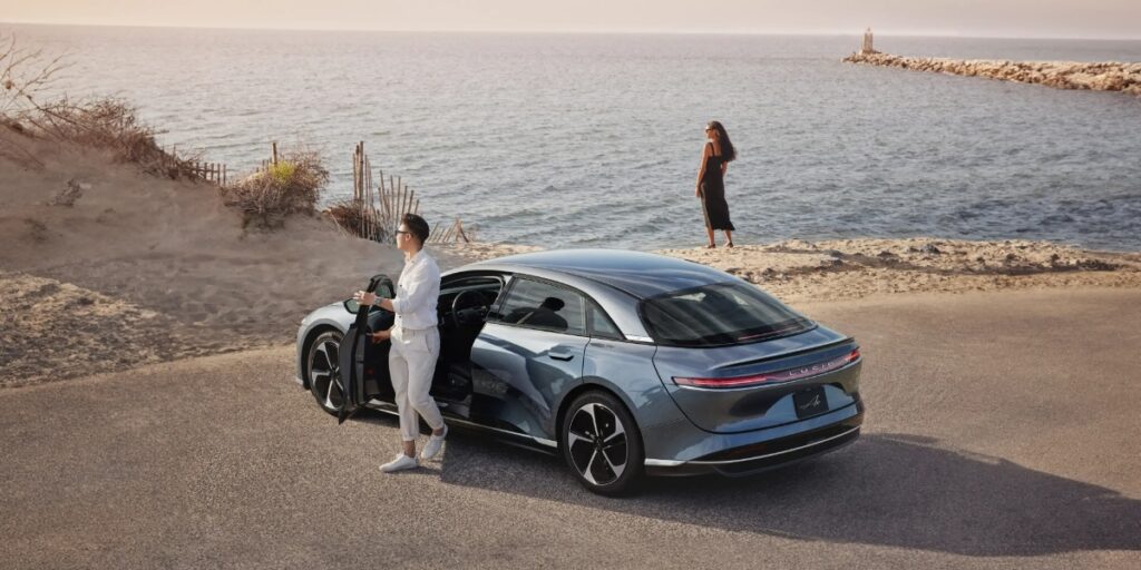 10 Most Eco-Friendly Cars for Different Lifestyles in 2026 5 Sleek Lucid Air Pure electric vehicle concept parked by the ocean, showcasing modern design against a scenic backdrop.