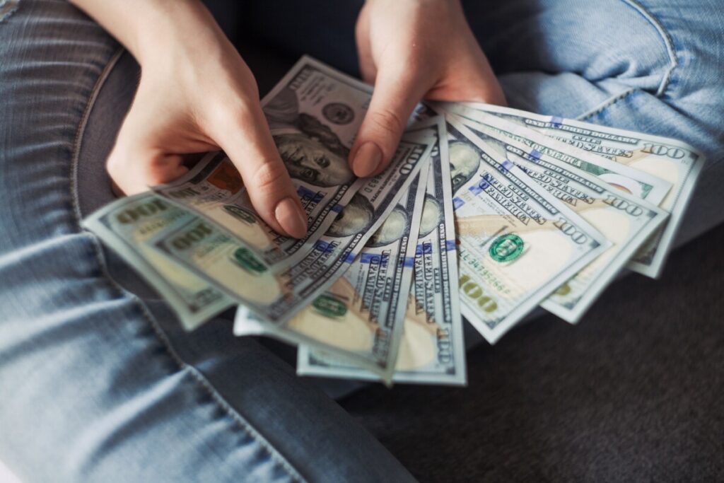 Is R410A Bad for the Environment? 11 Hands holding US dollar paper bills