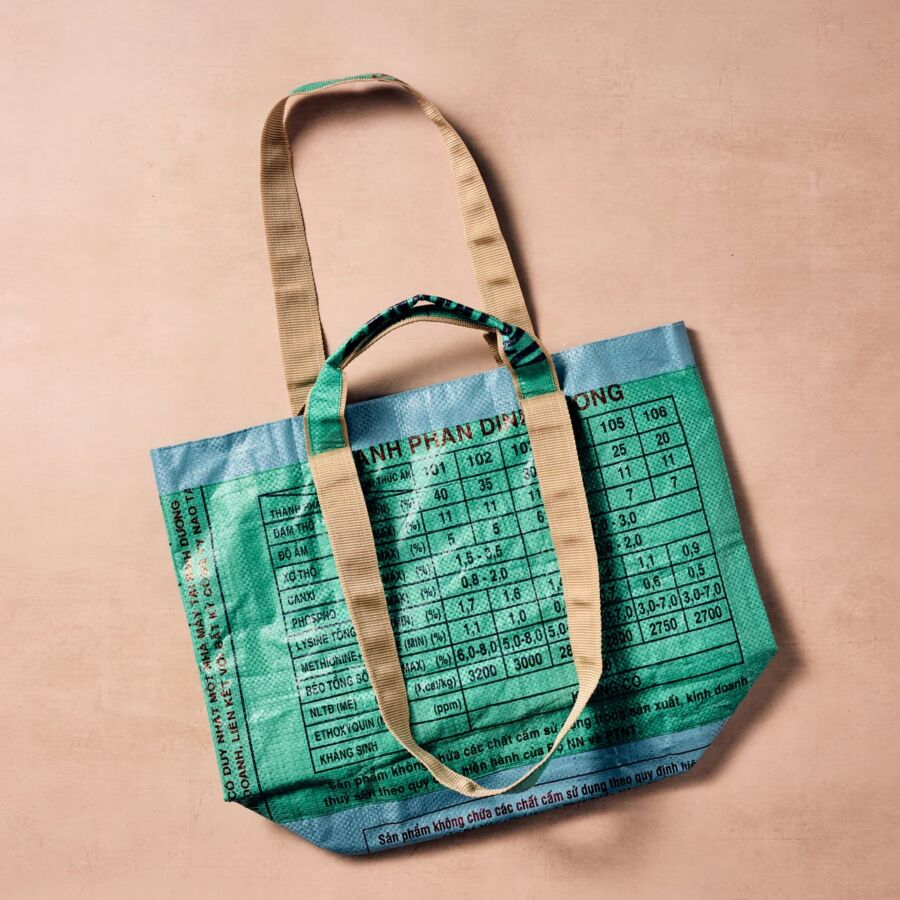 10 Best Fair Trade Handbags for 2026 4 Green tote bag featuring a world map design, made from recycled materials by Ten Thousand Villages.