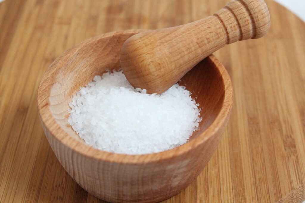 Is Ice Melt Bad for the Environment? 11 Rock salt on a wooden mortar and pestle
