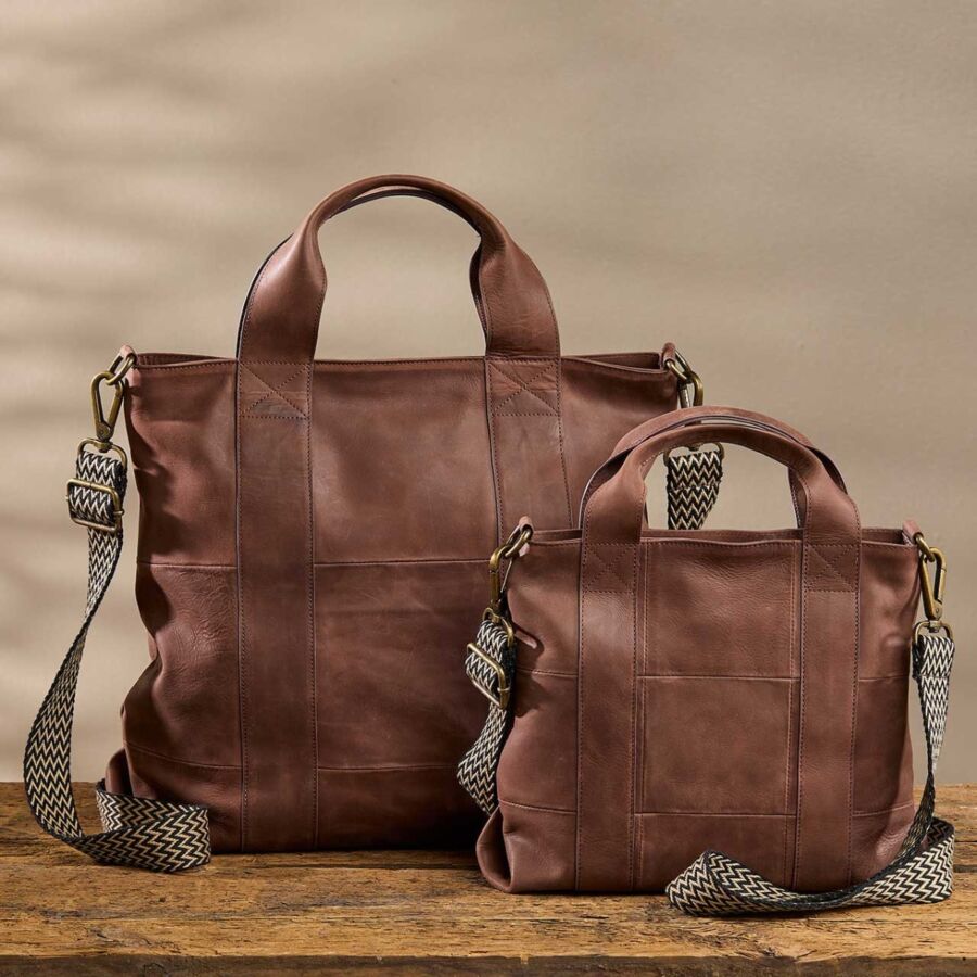 10 Best Fair Trade Handbags for 2026 17 Two brown leather totes displayed on a table, showcasing their elegant design and craftsmanship.