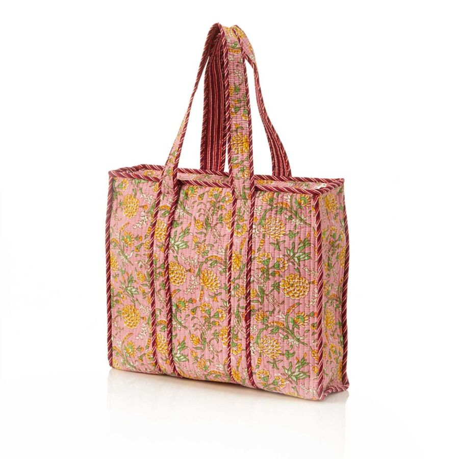 10 Best Fair Trade Handbags for 2026 9 Pink quilted tote bag featuring a vibrant floral pattern, ideal for stylish and functional everyday use.
