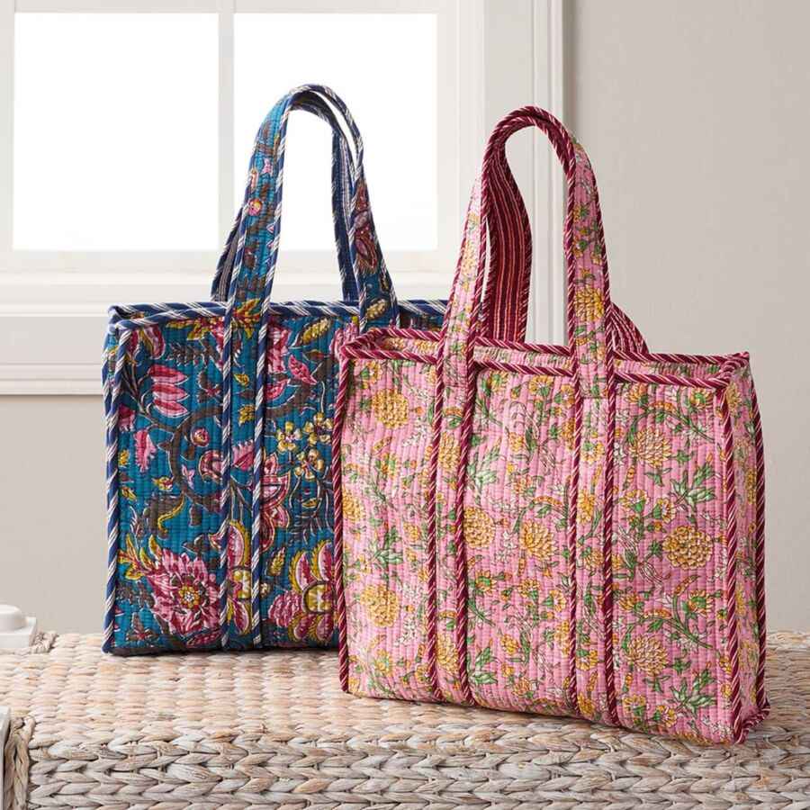 10 Best Fair Trade Handbags for 2026 41 Two colorful tote bags featuring vibrant floral designs in marigold and blush hues, showcasing a quilted texture.