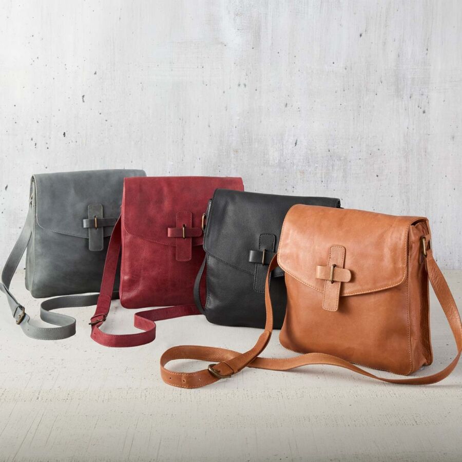 10 Best Fair Trade Handbags for 2026 1 Three leather Kolkata crossbody bags in different colors displayed on a white surface.