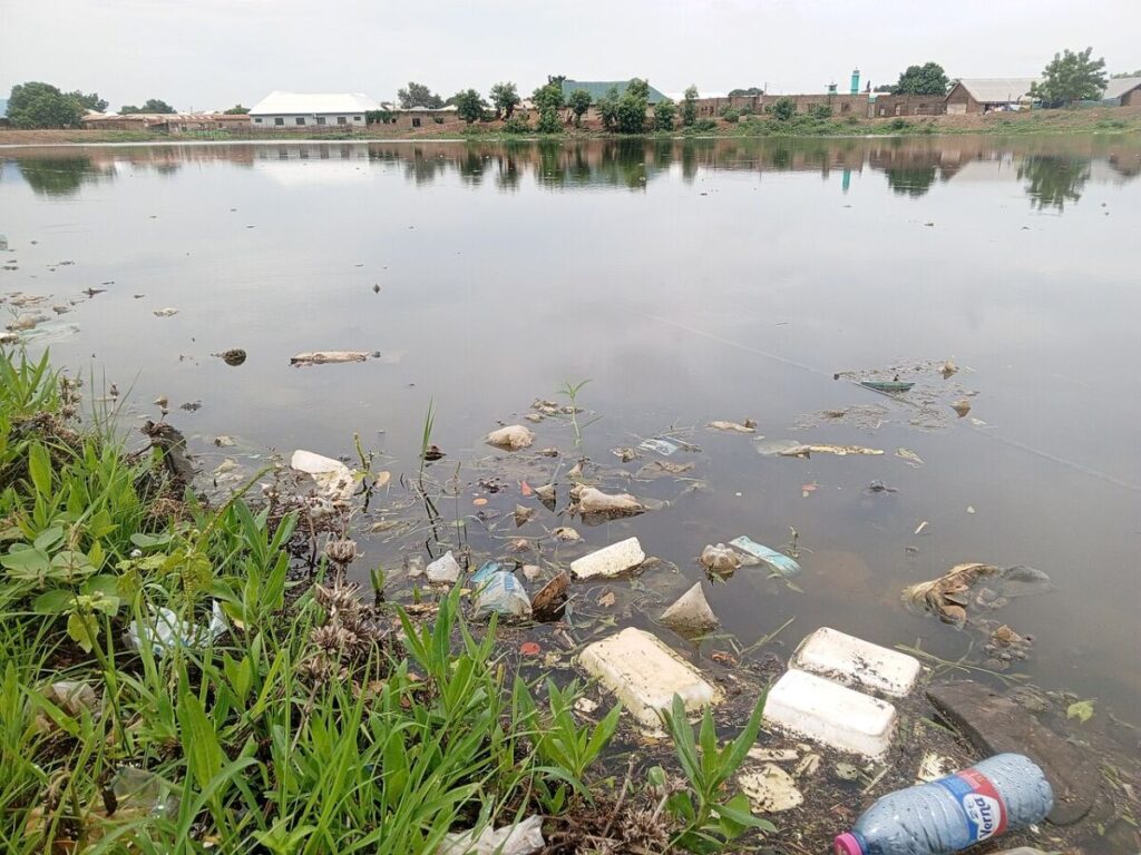 4 Types of Water Pollution: Sources, Effects, and Examples 4 Polluted lake in Northern Ghana, filled with trash and plastic bottles, highlighting environmental concerns.