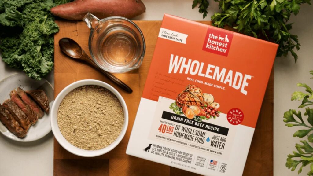 Box of The Honest Kitchen beef dog food displayed on a wooden cutting board, emphasizing its wholesome ingredients.