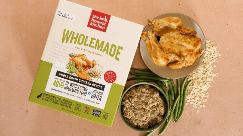 The Honest Kitchen dog food package displaying whole chicken and vegetables, highlighting a nutritious meal option for dogs.
