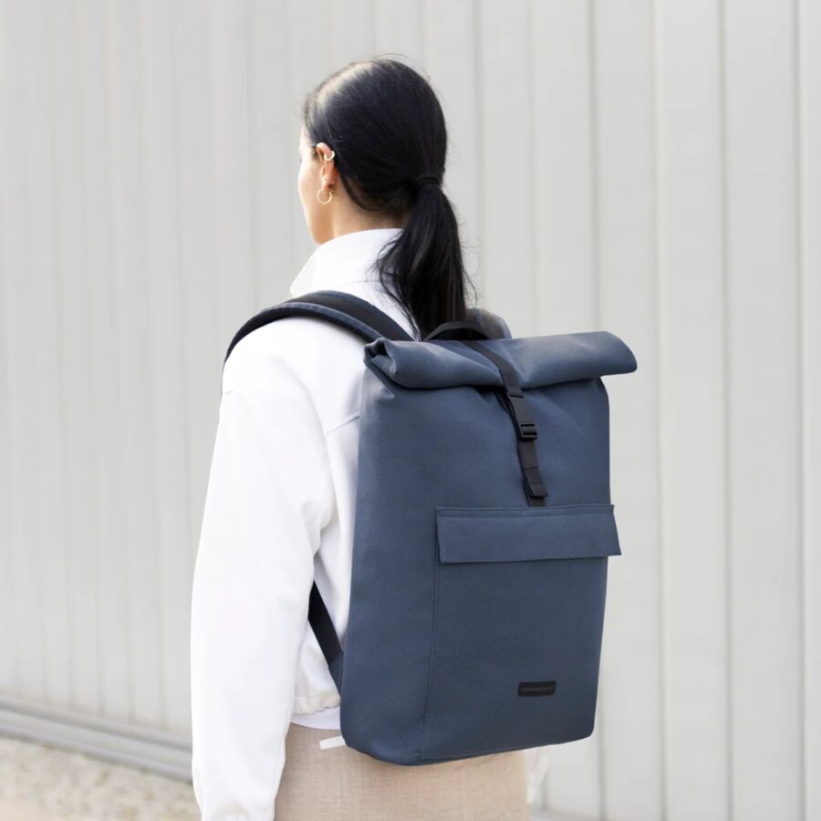 25 Best Vegan Backpacks for Work & Travel (2026) 32 Back view of a woman with a blue backpack, showcasing the Ucon Acrobatics Jannik Medium design.