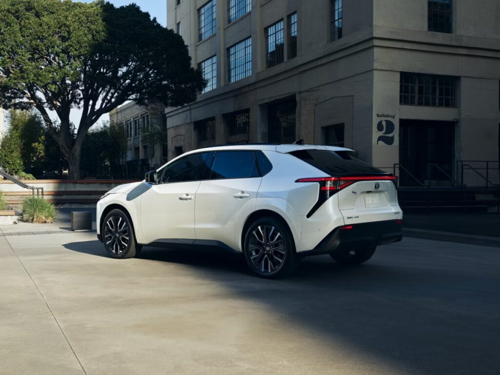 10 Most Eco-Friendly Cars for Different Lifestyles in 2026 8 The 2020 Toyota bZ XLE FWD Plus in white is parked on a city street, highlighting its modern features against an urban backdrop.