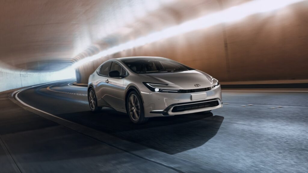 10 Most Eco-Friendly Cars for Different Lifestyles in 2026 10 Toyota Prius LE driving through a dimly lit tunnel, showcasing its sleek design and modern features.
