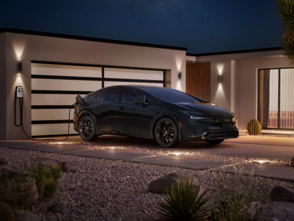 10 Most Eco-Friendly Cars for Different Lifestyles in 2026 11 Nighttime view of Toyota Prius Plug-in Hybrid SE parked outside a house, with soft lighting highlighting its modern features.