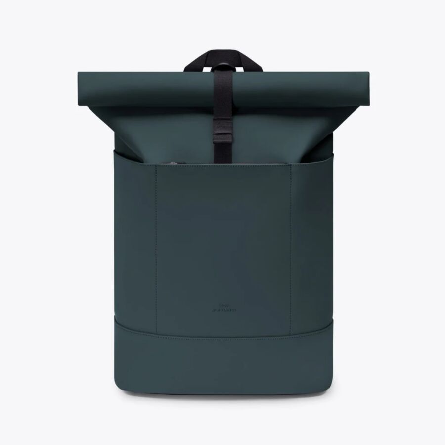 25 Best Vegan Backpacks for Work & Travel (2026) 16 Dark green Ucon Acrobatics Hajo Medium Pannier backpack viewed from the back, highlighting its minimalist style and functionality.